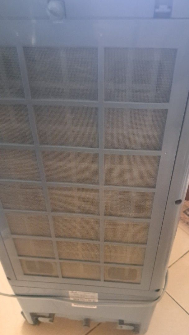 Asahi IC-009 Air Cooler (Category: Air Conditioning and Heating) located in Manila. Submitted by noobsaibot84901 (Listing ID 1469958053, Image 2). Description: - Brand/Model: Asahi IC-009 Air Cooler - Color: Sleek Grey - Controls: Top panel buttons for timer, mode, oscillation, ionizer, speed, and cooling - Features: Back mesh filter and adjustable front louvers for directed airflow - Power: Convenient main on/off switch - Condition: Powers on an