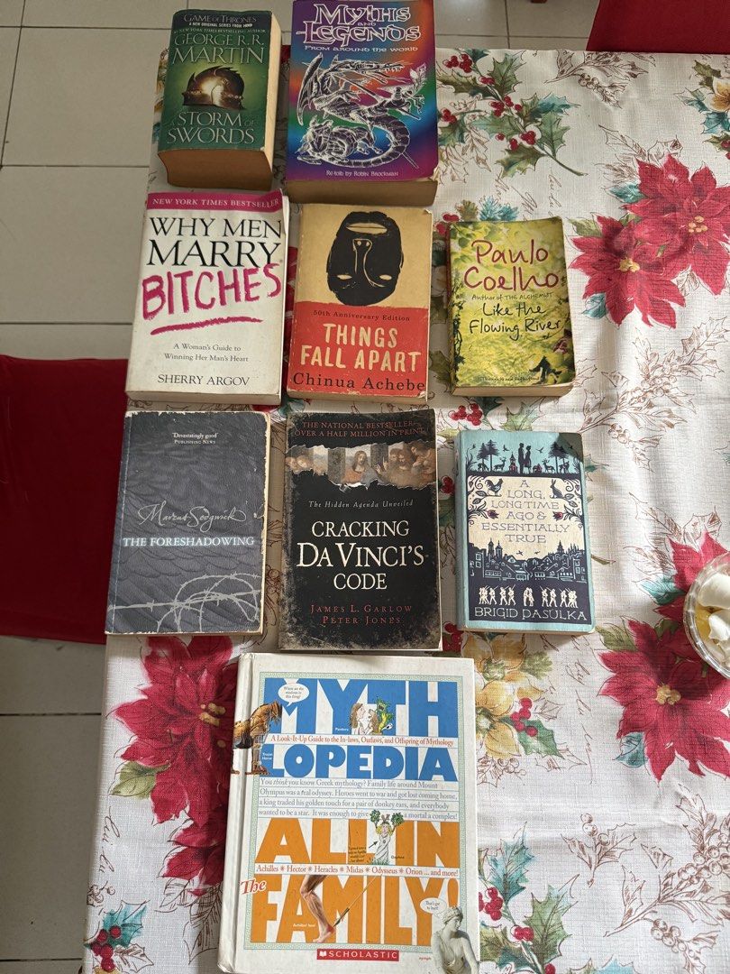 Assorted Fiction and Non-Fiction Paperbacks and Hardcovers (Category: Storybooks) located in Rizal. Submitted by aclawin (Listing ID 1469953004, Image 1). Description: - Selling for P40 each featuring a mix of fantasy, mythology, self-help, and novels - Includes popular titles: Game of Thrones: A Storm of Swords, Things Fall Apart, Why Men Marry Bitches, Cracking Da Vinci's Code, and Mythlopedia - Authors include George R.R. Martin, Chinua Achebe