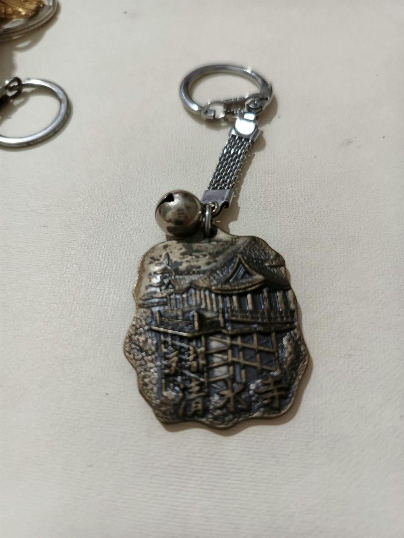 Assorted Souvenir Keychains Japan Austria Africa (Category: Vintage Collectibles) located in Abucay. Submitted by thrifty.picked (Listing ID 1470105898, Image 2). Description: - Assorted metal souvenir keychains from international travels - Includes: Japanese temple charm with bell, Abukuma Cave token, bronze rhinoceros head, Japanese Daruma doll bell, and Edelweiss Austria medallion - Made of durable, high-detail metal - Perfect for keys, bags, 