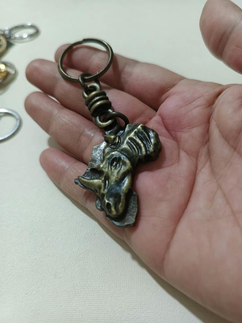 Assorted Souvenir Keychains Japan Austria Africa (Category: Vintage Collectibles) located in Abucay. Submitted by thrifty.picked (Listing ID 1470105898, Image 3). Description: - Assorted metal souvenir keychains from international travels - Includes: Japanese temple charm with bell, Abukuma Cave token, bronze rhinoceros head, Japanese Daruma doll bell, and Edelweiss Austria medallion - Made of durable, high-detail metal - Perfect for keys, bags, 