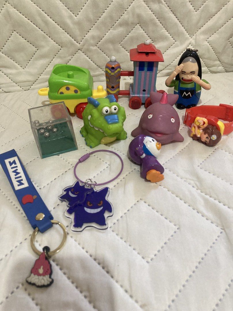 Assorted Vintage Toys and Keychains Lot (Category: Vintage Collectibles) located in Valenzuela. Submitted by theaveqc04360 (Listing ID 1470087287, Image 2). Description: - Assorted toy collection featuring Anpanman wind-up vehicles, Gengar double keychains, and a small puzzle cube - Includes various cartoon character figures and miniature train cars - Made of durable, brightly colored plastic materials - Ideal starter set for kids or a fun additi