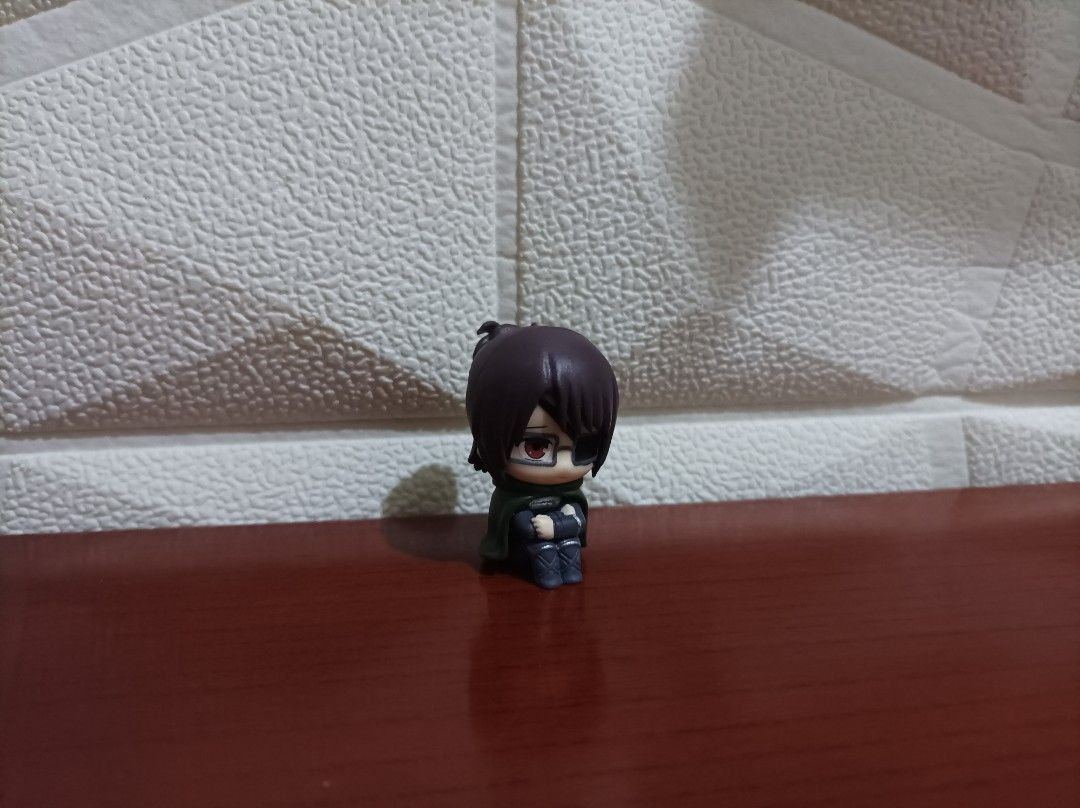 Attack on Titan Hange Zoe Chibi Mini Figure (Category: Figurines & Statues) located in Bacoor. Submitted by kuroochiii94695 (Listing ID 1469995001, Image 1). Description: - Character: Hange Zoe from Attack on Titan - Pose: Cute sitting pose, perfect for desk display - Details: Painted glasses, eyepatch, ponytail, and Survey Corps green cape/uniform - Condition: Loose item, no box included - Ideal for: Anime fans and collectors looking for small d