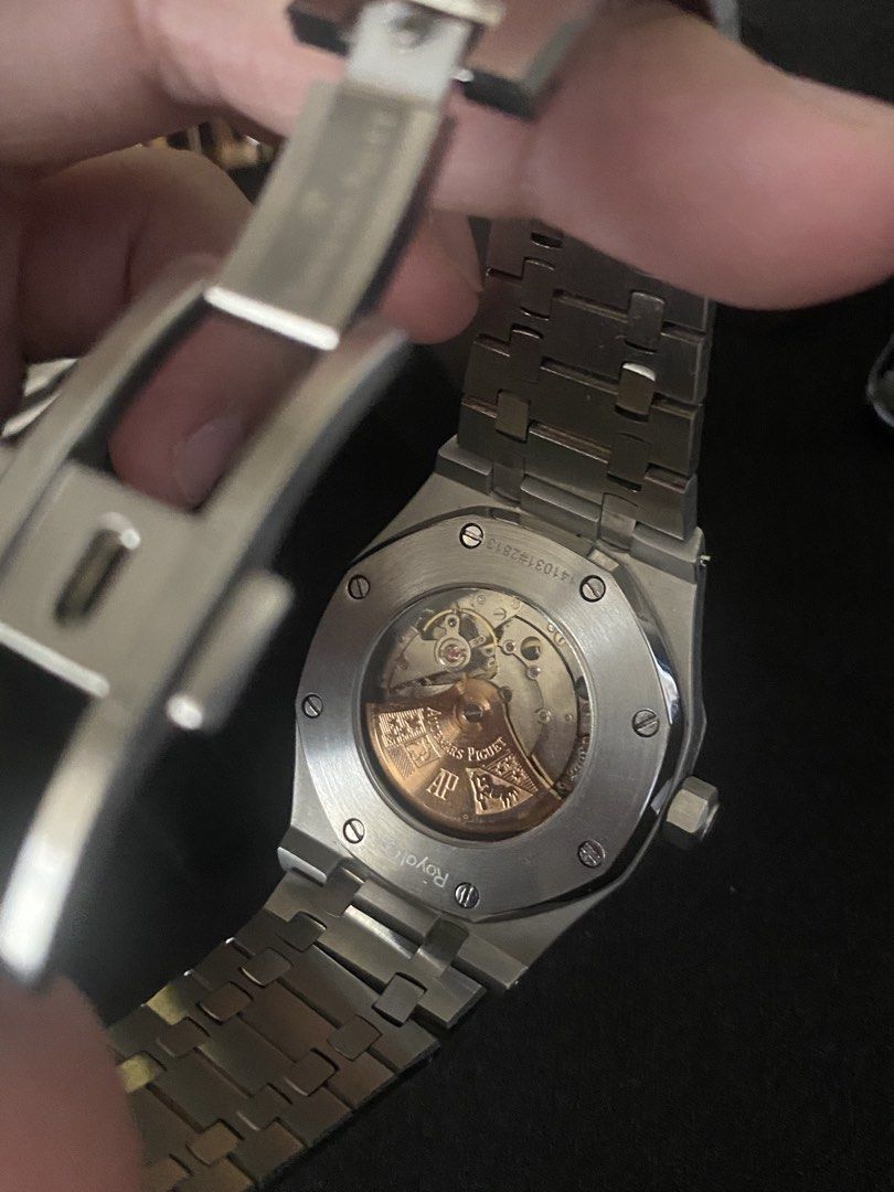 Audemars Piguet Royal Oak Automatic Watch (Category: Luxury Watches) located in Quezon City. Submitted by qiaoang (Listing ID 1469961354, Image 2). Description: - Brand: Audemars Piguet Royal Oak - Movement: Automatic with decorated gold rotor (exhibition caseback) - Material: Stainless steel case and integrated bracelet - Dial: Black textured dial with baton markers and date window at 3 o'clock - Clasp: Signed deployant clasp with AP logo - Cond