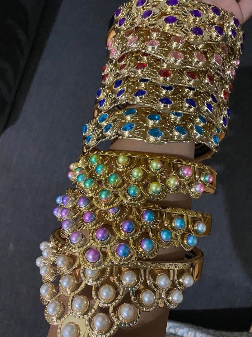 Audrey&Rachel crowns (Category: Bracelets) located in Manila. Submitted by sam_closet (Listing ID 1470060911, Image 1). Description: Gold Tone Rhinestone And Pearl Statement Bangles 300 each - Set of multiple gold-tone bangles with ornate scalloped and filigree metal designs - Features a dazzling mix of colorful rhinestones (purple, pink, red, blue) - Decorated with rainbow-colored and classic white pearl-like beads - Ideal for cultural events, d