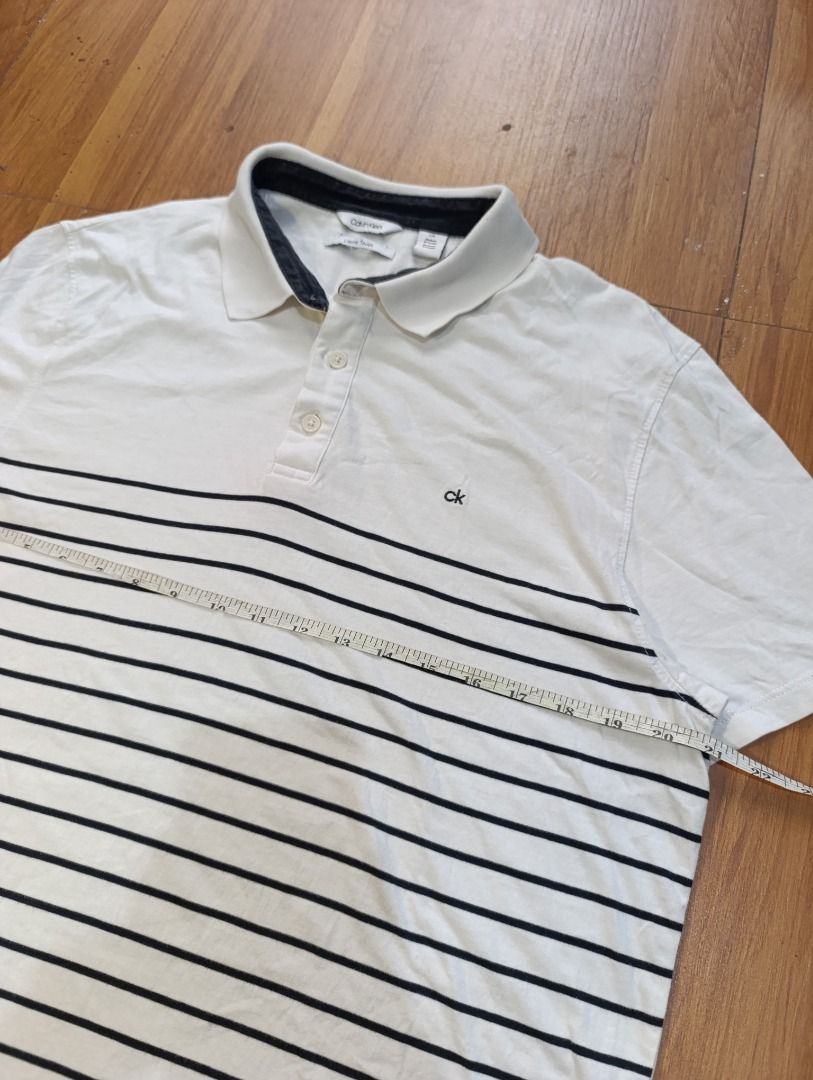 Authentic Calvin Klein Stripes Polo Shirt (Category: Tshirts & Polo Shirts ) located in Bulacan. Submitted by koritoo (Listing ID 1470010916, Image 2). Description: Authentic Calvin Klein Stripes Polo Shirt Good as new no issue Size L Dimensions: 21 Width 28.5 Length Color rate: 10/10.