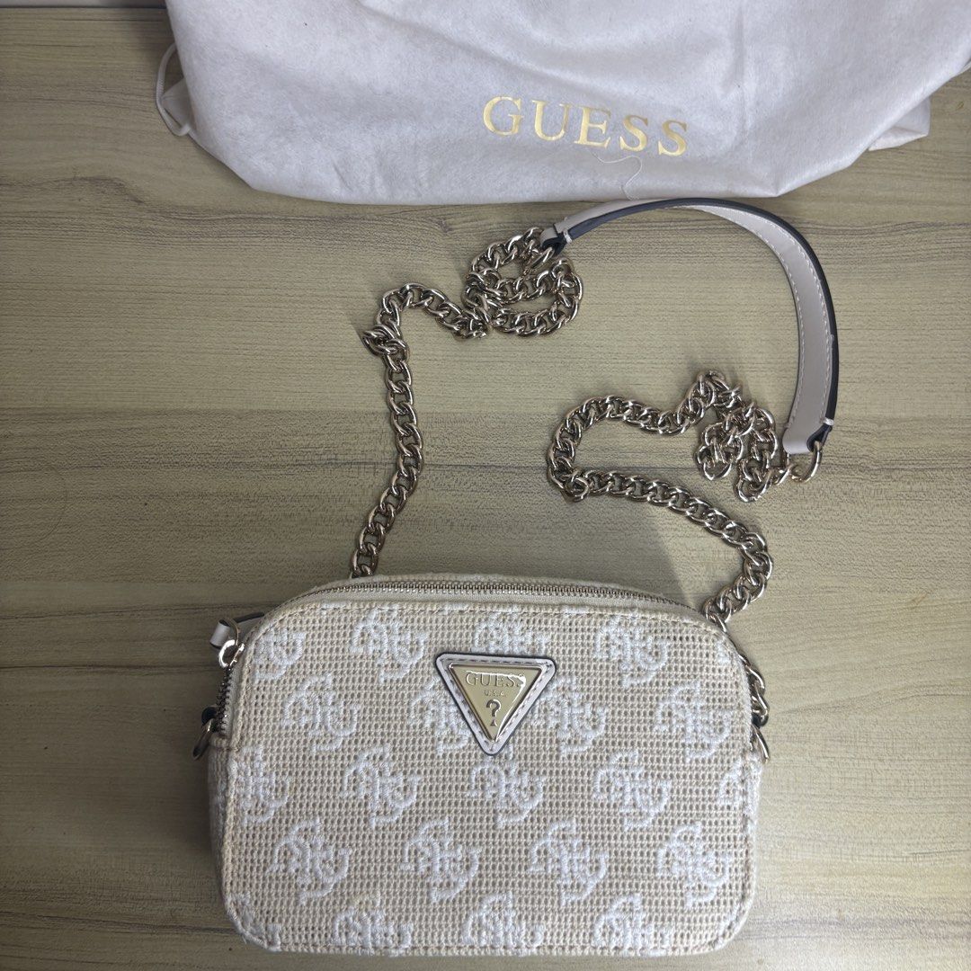 Authentic Guess White Crossbody Bag with Chain Strap (Category: Cross-body Bags) located in Angeles City. Submitted by muse_archive (Listing ID 1470047706, Image 3). Description: - Authentic Guess crossbody bag with iconic monogram pattern - with gold chain strap - with original Guess dust bag -No issues, no stains, the gold hardware is good as new. Used once lang! -Bought it for 7k+, selling it for 3k.