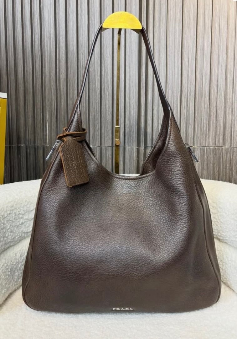 Authentic PRADA Cervo Hobo Bag (Category: Luxury Bags & Wallets) located in Quezon City. Submitted by noris_goods (Listing ID 1469949362, Image 1). Description: - Model: Cervo Hobo (1BC012) - Color: Bruciato (Dark Brown) - Inclusion: Original Prada authenticity card (stamped Prada Korea, dated Dec 18, 2016) - Mode of Payment: GCash, Cash, Bank Transfer - Can do meet-ups within Quezon City (Scout Area/Robinsons Magnolia) - DM for more details and 
