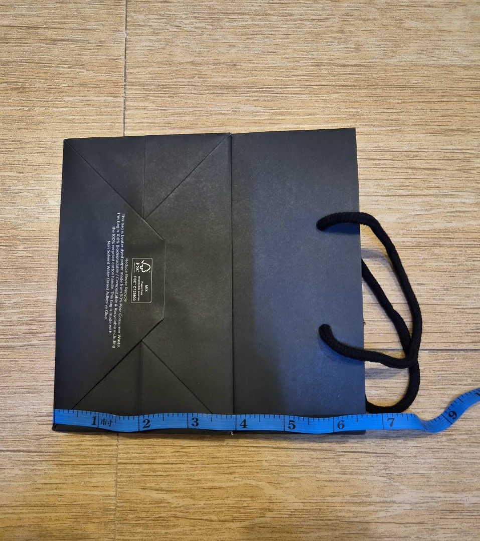 Authentic Ray-Ban Paper Gift Bag (Category: Tote Bags) located in Manila. Submitted by golden_brain (Listing ID 1470117586, Image 3). Description: - Authentic black Ray-Ban paper shopping bag - Features comfortable fabric handles and striking white Ray-Ban logo - Sturdy construction with a clean flat base - Eco-friendly FSC mix paper details on the bottom - Ideal for gifting, organizing, or storing small accessories.
