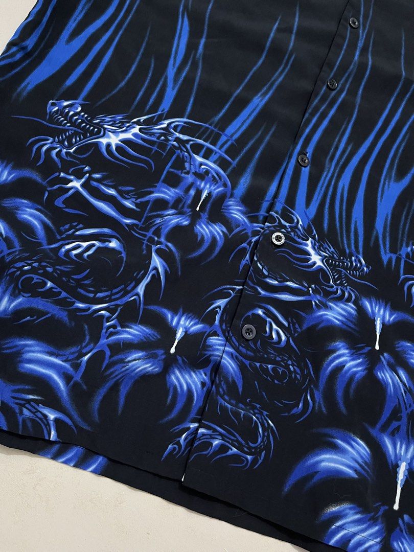Authentic Shaolin Blue Dragon Print Short Sleeve Shirt (Category: Tshirts & Polo Shirts ) located in Pasig City. Submitted by thousandthrift69 (Listing ID 1470070669, Image 2). Description: - Brand: Authentic Shaolin - Color: Black with striking blue dragon and flame graphics - Size: Large (Relaxed fit) - Material: 100% Polyester, Made in Korea - Style: Short sleeves, camp collar, bold graphic design - Condition: Excellent / Ready to wear.