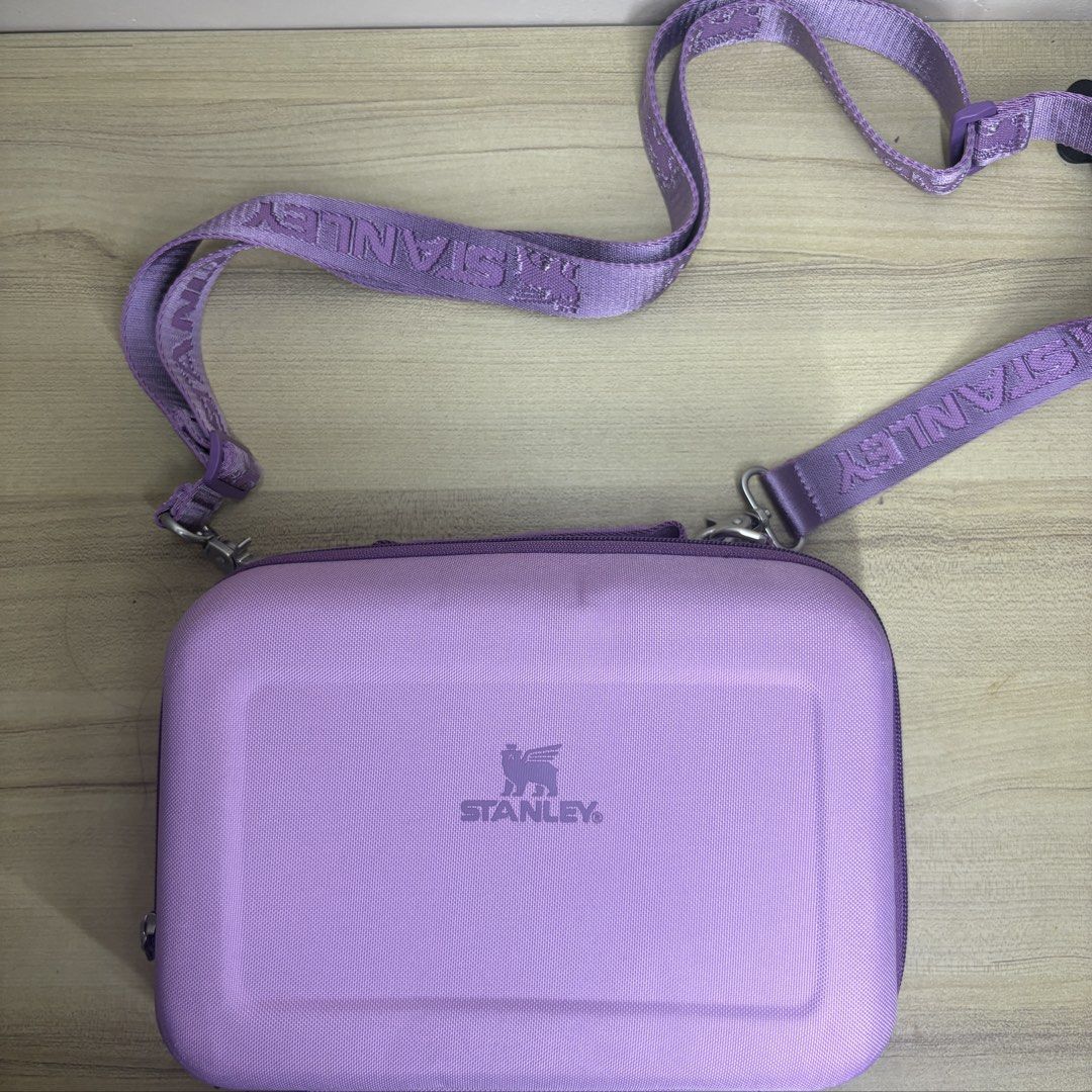 Authentic Stanley Purple All Day Lunch Box (Category: Cross-body Bags) located in Angeles City. Submitted by muse_archive (Listing ID 1470045702, Image 1). Description: - Brand new!! -with adjustable strap The All Day Lunch Box holds your lunch at the right temp for hours thanks to molded EVA insulation. The crush resistant EVA body holds its shape. An inner mesh pocket stores your silverware and a small snack. - with original tag, care booklet, 