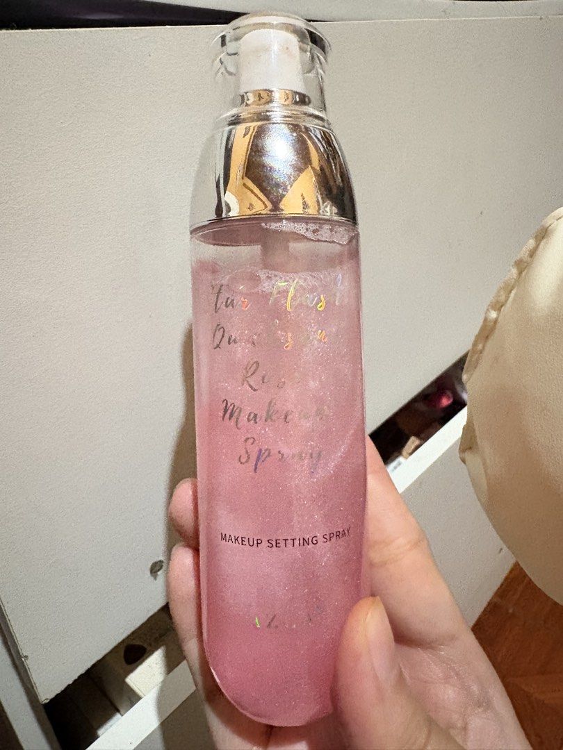 AZLA Star Flash Quicksand Rose Makeup Setting Spray (Category: Makeup) located in Baguio. Submitted by declutterbycys (Listing ID 1470075730, Image 2). Description: 98% Full - Brand: AZLA Star Flash Quicksand Rose Makeup Setting Spray - Condition: Barely used, bottle is nearly full - Finish: Matte finish with hydrating benefits - Formula: Waterproof and oil-controlling to lock makeup in place all day - Appearance: Pink liquid with stunning glitte