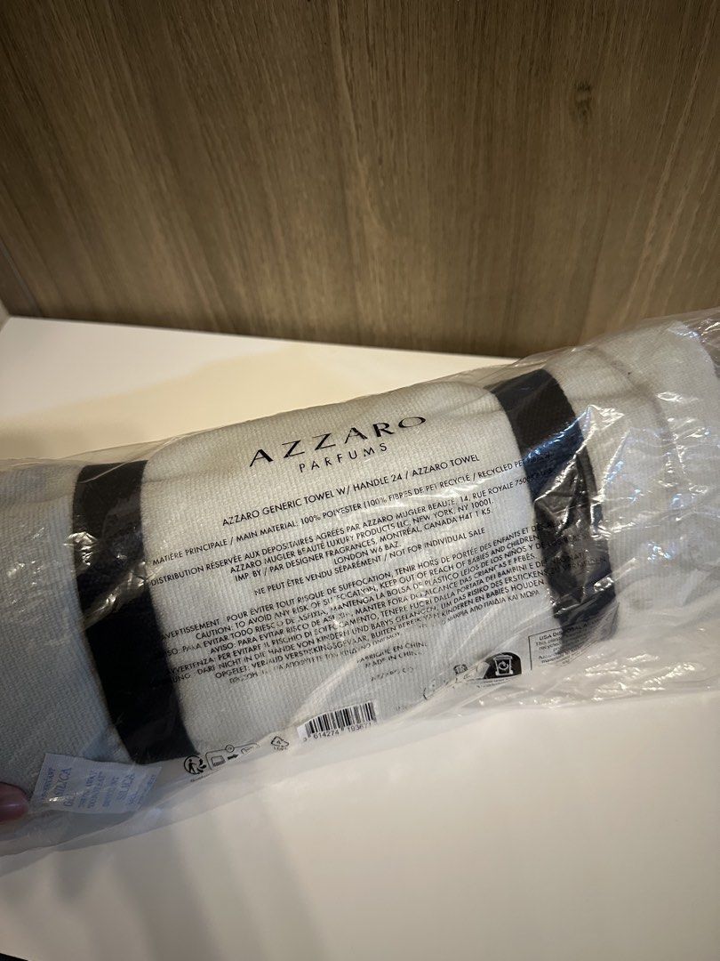 Azzaro Parfums Towel with Handle (Category: Face Care) located in Manila. Submitted by kevintotin49861 (Listing ID 1470089819, Image 2). Description: - 100% Official Azzaro Parfums promotional towel - Brand new, rolled up in original protective plastic packaging - Made from eco-friendly 100% polyester with recycled PET fibers - Features a sleek white and grey colorway with large printed branding - Includes a convenient black carry handle attached