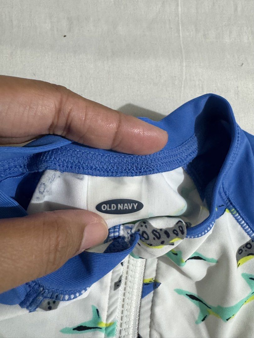 Baby Boy Swimsuit (Category: Babies & Kids Fashion) located in Paranaque City. Submitted by april_anythingpreloved (Listing ID 1470097363, Image 2). Description: - Brand: Old Navy - Design: Fun all-over shark pattern (blue, green, and grey on a white base) - Style: Short sleeves and short legs - Feature: Front zipper for quick and easy diaper changes - Condition: Excellent / Ready for use - Bought in the US - RFS: Decluttering - Location: Paranaq
