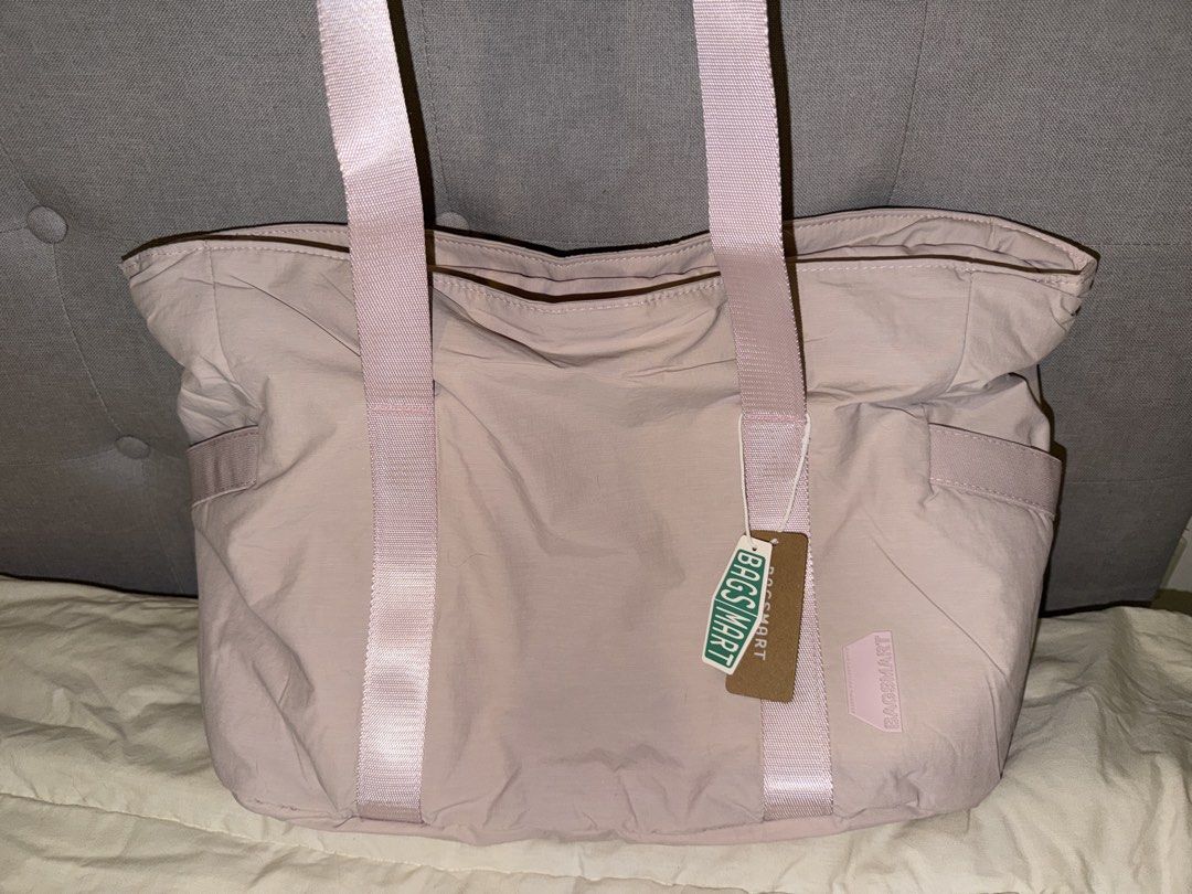 Bagsmart Pink Tote Bag (Category: Tote Bags) located in General Trias. Submitted by tmbychc (Listing ID 1470077567, Image 1). Description: BRAND NEW! Never been used, with tags still attached and with plastic (opened) - Large main compartment with zipper closure, multiple pockets - Fits a 15.6 inch laptop - Side pockets, can fit water bottle, umbrellas - Extra straps for yoga mat (removable) location: General Trias, Cavite lamove or ggx.