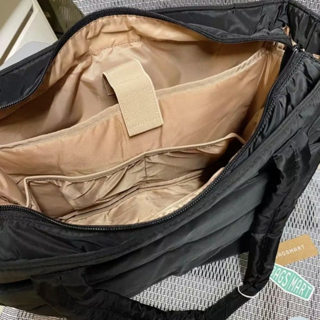BAGSMART Puffer Tote Bag MEDIUM (Category: Tote Bags) located in Taguig. Submitted by rrdurant (Listing ID 1470021729, Image 3). Description: - Brand: BAGSMART - Color: Classic Black - Dimensions: 13.8" x 6.3" x 19.3" - Laptop Capacity: Fits up to a 15.6-inch laptop securely with a Velcro strap - Exterior: Soft quilted nylon with convenient side pockets and sturdy dual shoulder straps - Interior: Chic beige lining equipped with multiple organizat
