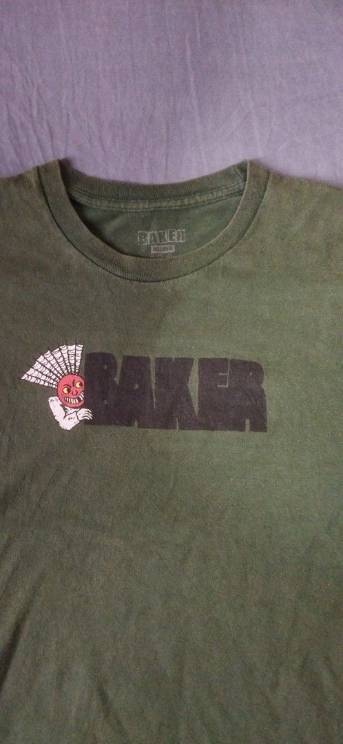 Baker Skateboards Green Graphic Tee (Category: Tshirts & Polo Shirts ) located in Caloocan City. Submitted by onethriftjel (Listing ID 1470131028, Image 2). Description: - Brand: Baker Skateboards - Color: Green with faded wash look - Size: Medium (tag printed inside collar) - Design: Classic chest logo graphic with iconic devil character illustration - Details: Crew neck, short sleeves - Material: Soft cotton - Condition: Great skater staple pie