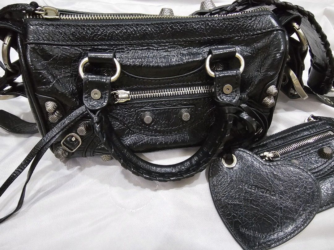 Balenciaga Le Cagole Duffle (Category: Luxury Bags & Wallets) located in Makati City. Submitted by stephanie48_whale (Listing ID 1470127099, Image 1). Description: Moving back sales , no dust bag , no cert , AUTHENTIC NO FAKE , slightly nego for serious buyer - Brand: Balenciaga - Material: Black crinkled leather with striking silver hardware and studs - Design: Edgy and compact everyday carryall - Features: Comfortable braided handles and a conv