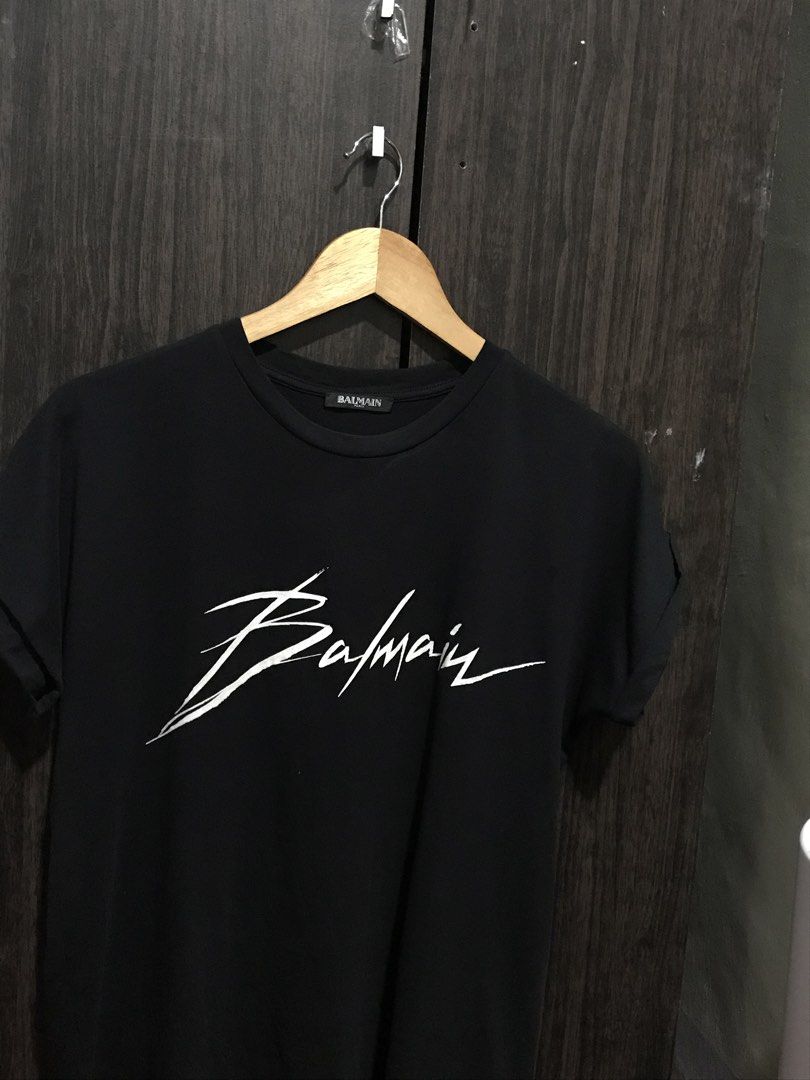 Balmain Paris Signature Logo Shirt (Category: Luxury Apparel) located in Bulacan. Submitted by dailybumps (Listing ID 1470036507, Image 1). Description: 21x26 Authentic No issue This is a Balmain Signature Logo Shirt featuring a white handwritten-style Balmain script logo on the chest..