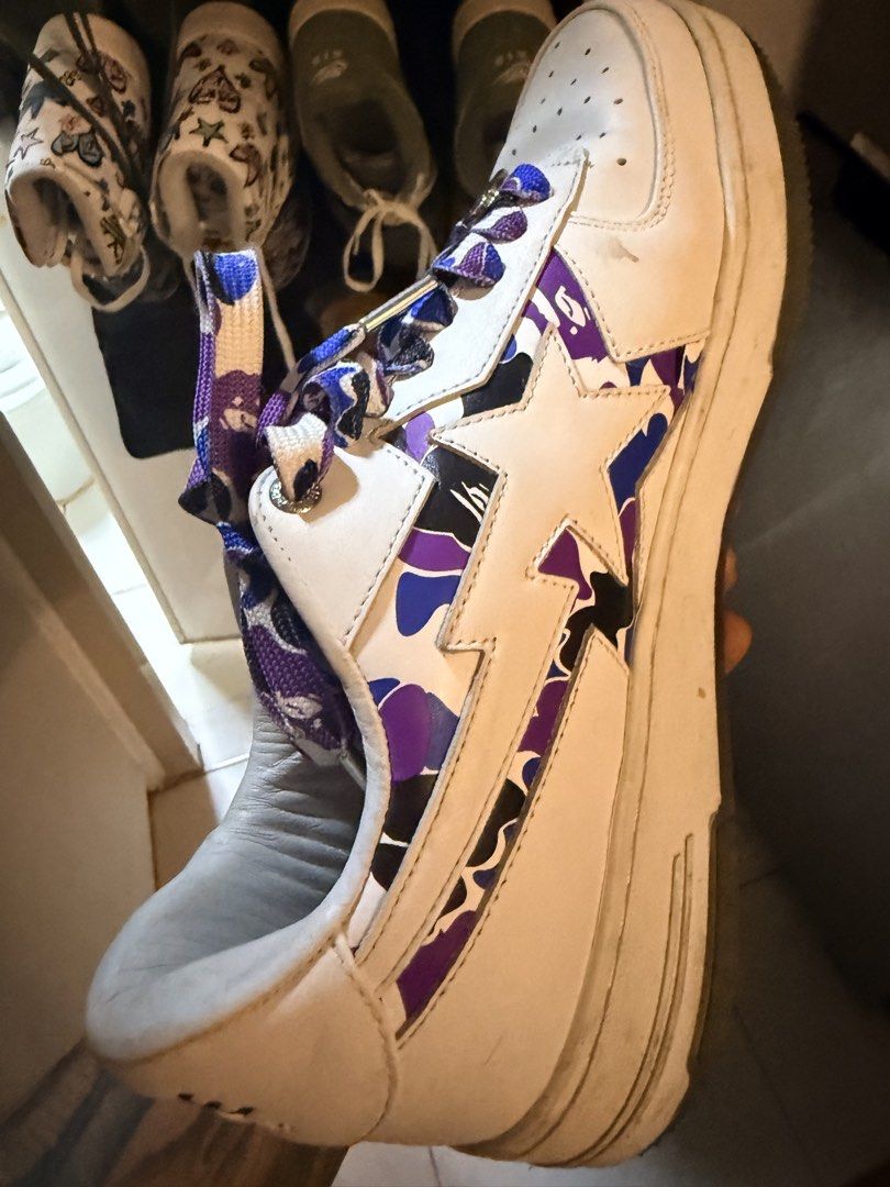 BAPE Sta Purple Camo Sneakers (Category: Sneakers) located in Caloocan City. Submitted by ninomendoz48209 (Listing ID 1470040054, Image 1). Description: - Brand: BAPE (A Bathing Ape) - Model: BAPE Sta Low - Colorway: White with Purple Camo star logo - Special Features: Custom printed laces, purple insoles with Bape Store Hong Kong branding, and translucent rubber sole with shark teeth graphic - Condition: General wear on midsoles and bottom soles