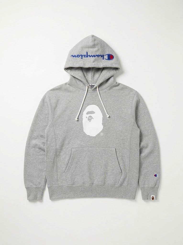 BAPE x Champion Reverse Weave Pullover Hoodie Grey X-Large (Category: Hoodies) located in Manila. Submitted by lec.loots (Listing ID 1470115431, Image 1). Description: - Brand: BAPE x Champion Collaboration - Color: Grey Heather - Size: X-Large (XL) - Material: Heavy cotton blend reverse weave fabric - Design: Large white APE head graphic on chest - Branding: Embroidered Champion logos on hood and left sleeve cuff, BAPE woven sleeve tag - Details