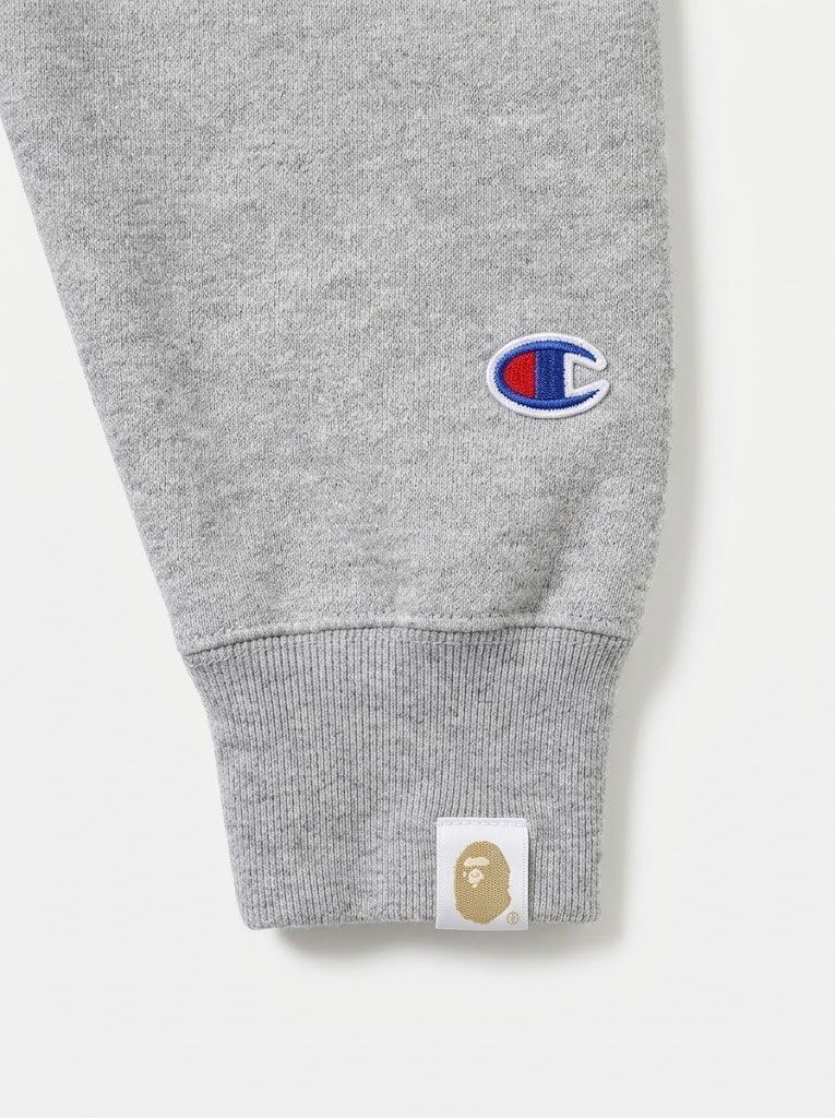 BAPE x Champion Reverse Weave Pullover Hoodie Grey X-Large (Category: Hoodies) located in Manila. Submitted by lec.loots (Listing ID 1470115431, Image 3). Description: - Brand: BAPE x Champion Collaboration - Color: Grey Heather - Size: X-Large (XL) - Material: Heavy cotton blend reverse weave fabric - Design: Large white APE head graphic on chest - Branding: Embroidered Champion logos on hood and left sleeve cuff, BAPE woven sleeve tag - Details