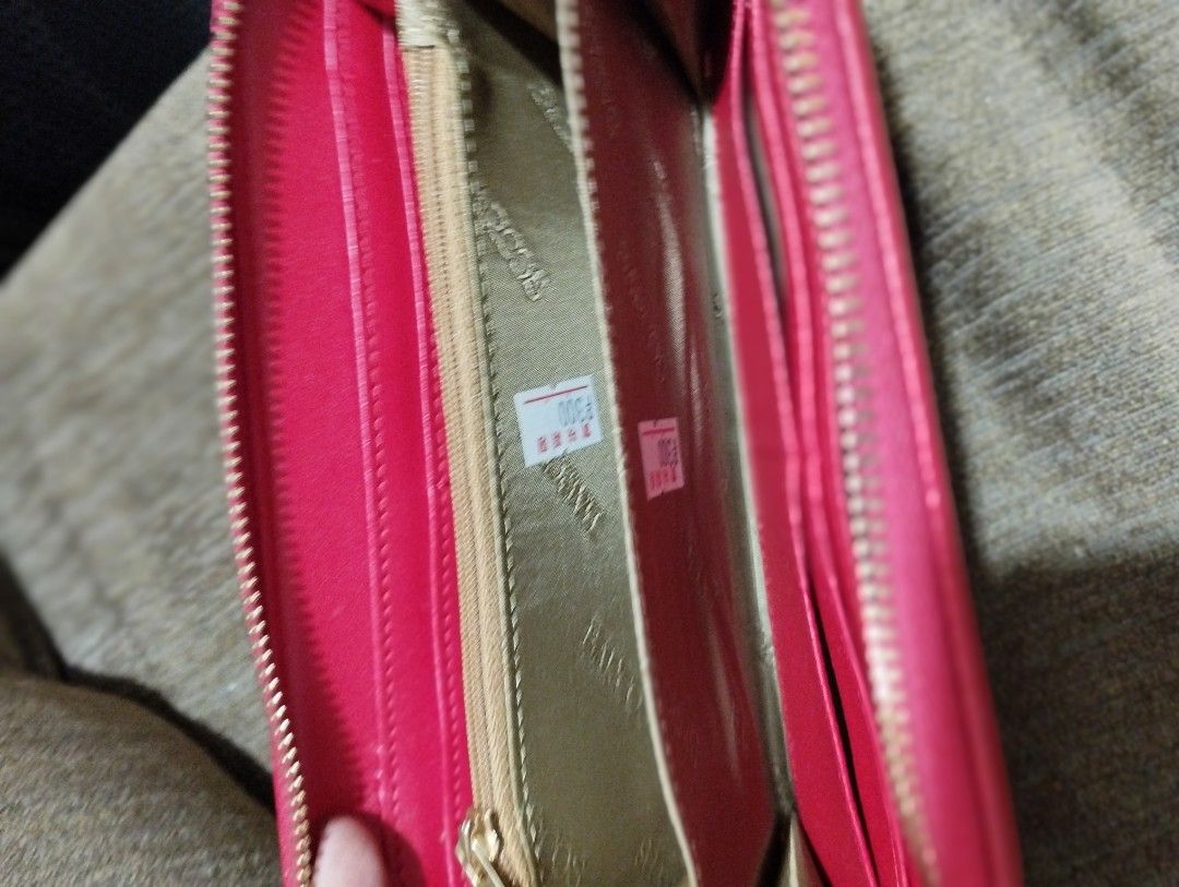 BARCOS Pink Zip-Around Wallet (Category: Wallets & Card holders) located in Caloocan City. Submitted by chonadura91470 (Listing ID 1470094939, Image 3). Description: - Brand: BARCOS - Color: Bright pink leather with gold-tone hardware - Closure: Secure zip-around design - Interior: Multiple card slots, bill compartments, and a zippered coin pocket with gold branded lining - Size: Compact, fits easily into any handbag - Condition: Clean inside and