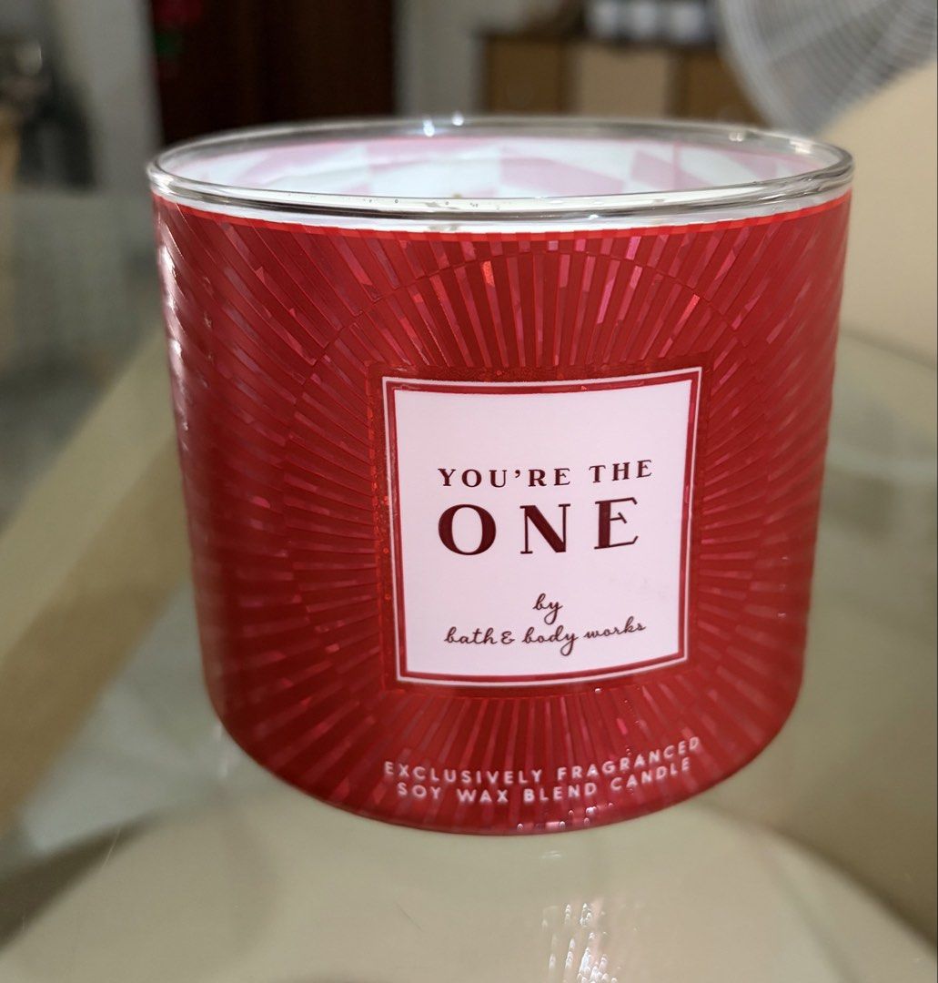 Bath & Body 3 wick scented candle (Category: Home Fragrance) located in Manila. Submitted by ejshop82 (Listing ID 1469996181, Image 2). Description: - Brand: Bath & Body Works - Product: 3-wick scented candle - Fragrance: You're the One - Wax Type: Soy wax blend - Design: Red textured glass jar with metallic silver lid - Condition: Brand new, unused - Meetup location: SM San Lazaro Activity Center.