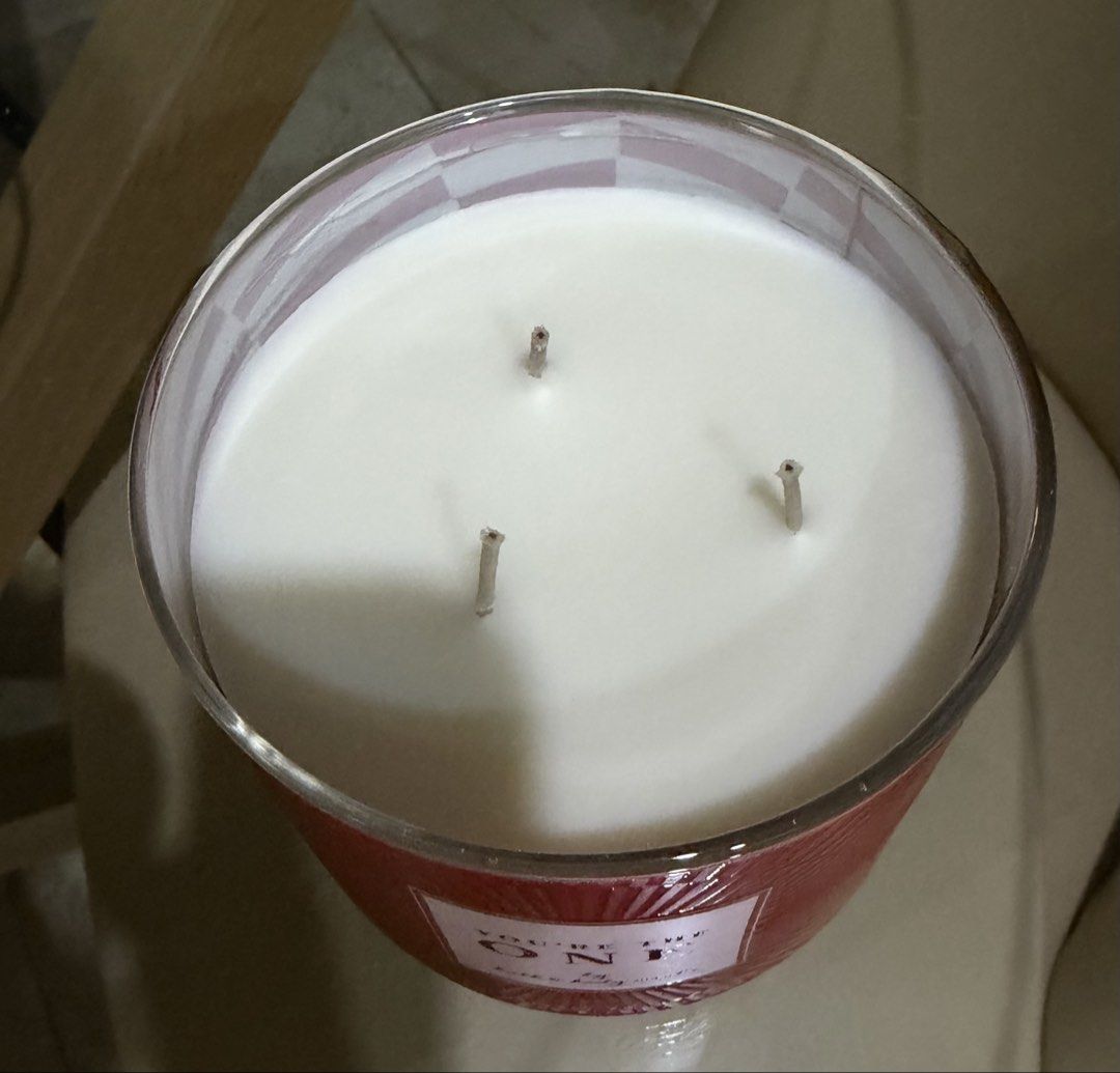 Bath & Body 3 wick scented candle (Category: Home Fragrance) located in Manila. Submitted by ejshop82 (Listing ID 1469996181, Image 3). Description: - Brand: Bath & Body Works - Product: 3-wick scented candle - Fragrance: You're the One - Wax Type: Soy wax blend - Design: Red textured glass jar with metallic silver lid - Condition: Brand new, unused - Meetup location: SM San Lazaro Activity Center.