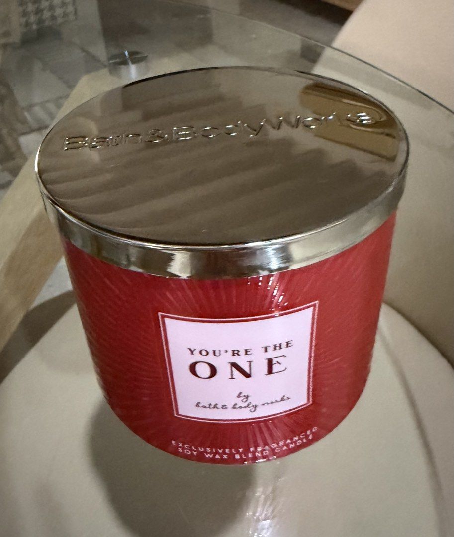 Bath & Body 3 wick scented candle (Category: Home Fragrance) located in Manila. Submitted by ejshop82 (Listing ID 1469996181, Image 1). Description: - Brand: Bath & Body Works - Product: 3-wick scented candle - Fragrance: You're the One - Wax Type: Soy wax blend - Design: Red textured glass jar with metallic silver lid - Condition: Brand new, unused - Meetup location: SM San Lazaro Activity Center.