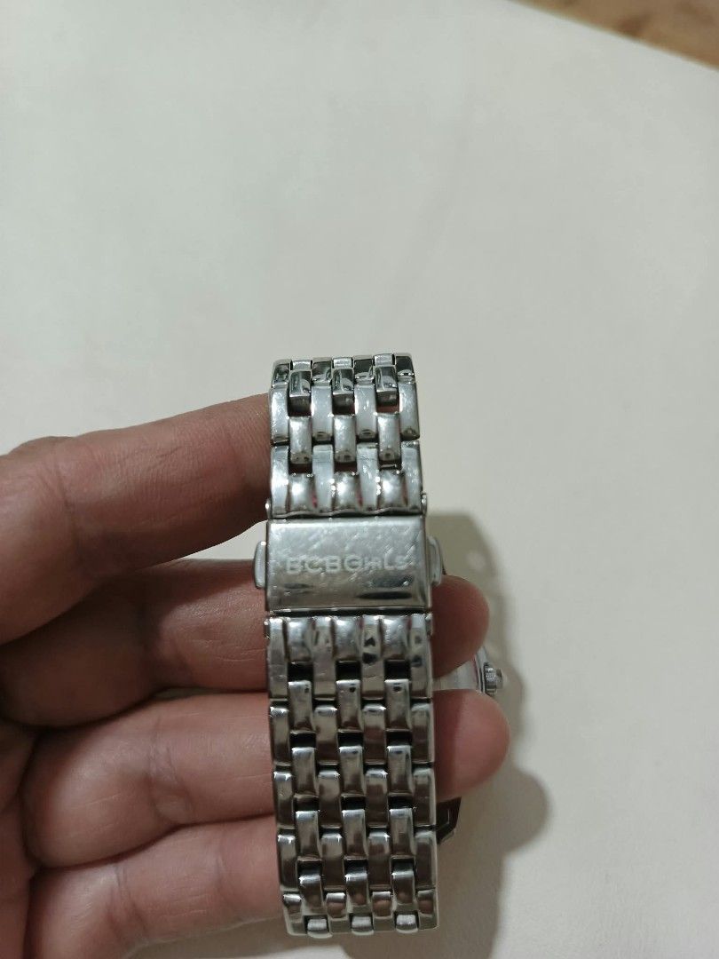 BCBGGirls Silver Tone Rhinestone Watch (Category: Women's Watches) located in Abucay. Submitted by thrifty.picked (Listing ID 1470123624, Image 2). Description: - Brand: BCBGGirls - Color: Silver tone - Dial: Mother of pearl covered in rhinestone details with a sparkling crystal bezel - Closure: Link bracelet with fold-over clasp - Features: Stainless steel back, water resistant, Japan movement - Condition: Minor wear on the metal surface.