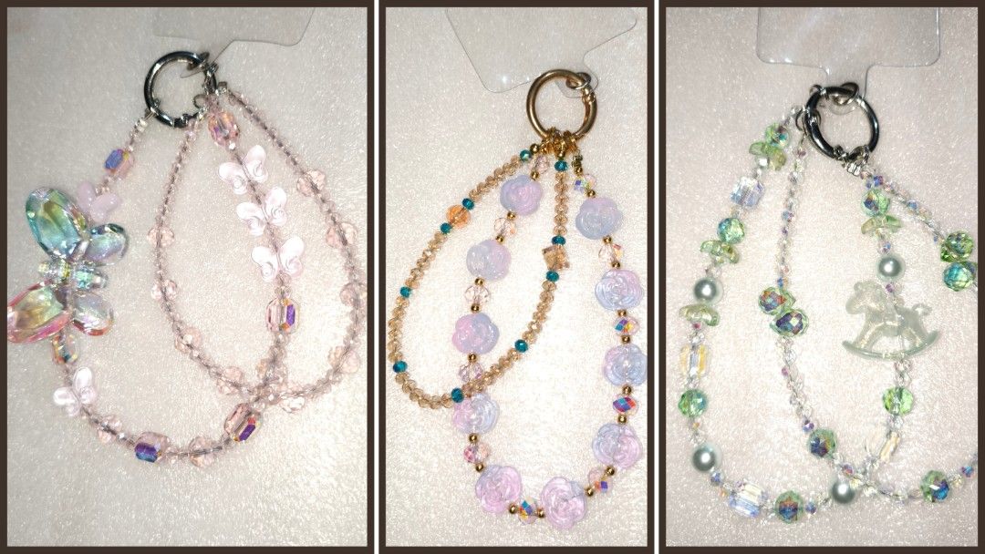 Beaded Phone Charm Wrist Strap (Category: Charms) located in Caloocan City. Submitted by books_and_beads (Listing ID 1470081662, Image 1). Description: - Handmade multi-strand beaded wrist strap - Features cute butterfly, rose, and rocking horse pendants: · Left Chain: A truly ethereal, fairy-princess design. It features a massive, iridescent mermaid-core butterfly alongside delicate rose-pink butterfly charms, all strung on a translucent pink be