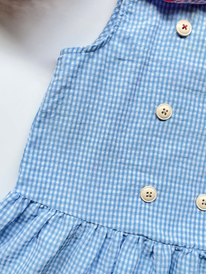 Bebe De Pino Blue Gingham Sailor Dress with Bunny Patch (Category: Babies & Kids Fashion) located in Davao. Submitted by epicdeer.54cf0e (Listing ID 1470092065, Image 2). Description: - Brand: Bebe De Pino - Size: 90 - Color: Light blue and white checkered - Design: Sailor collar with red edging, double-breasted buttons, and an adorable rabbit patch - Style: Sleeveless with a playful pleated skirt - Condition: Has some red color transfer on the c