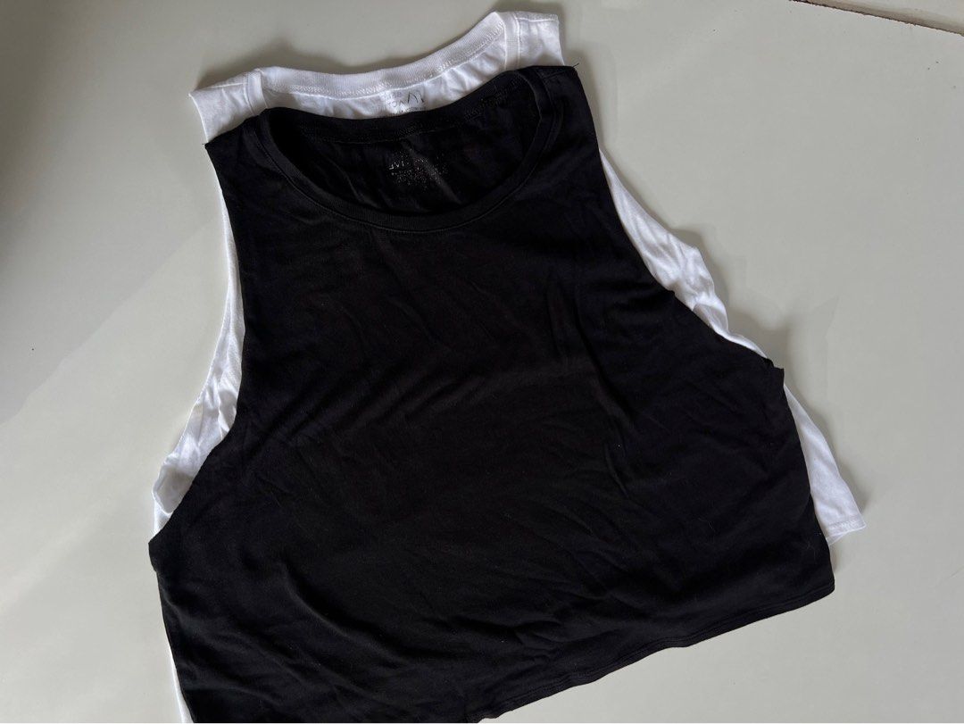 Bench Women’s Muscle Tee 2 Pcs (Category: Activewear) located in Santiago. Submitted by ricevllnz (Listing ID 1469958540, Image 1). Description: Basic but versatile muscle tees from BENCH, perfect for casual outfits, layering, or everyday wear. * Brand: Bench * Colors: Black and white * Style: Sleeveless muscle tee * Fit: Casual, relaxed style * Condition: Preloved Easy to pair with leggings, biker shorts, joggers, or jeans for a simple, sporty l