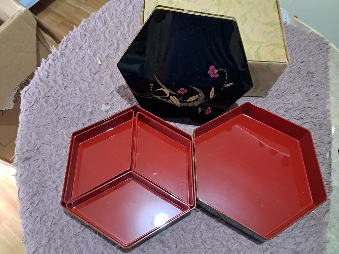 Bento box gift set (Category: Dinnerware & Cutlery) located in Cavite. Submitted by secretjapansurplus (Listing ID 1469986618, Image 3). Description: Brand New Old Stock] Yumi Katsura Hexagonal 2-Tier Japanese Lacquerware Box • Condition: Brand New Old Stock (NOS). Unused, pristine, and glossy. Comes with the original box (box shows minor storage wear due to age). • Design: Elegant glossy black exterior featuring a floral motif and Yumi Katsura's