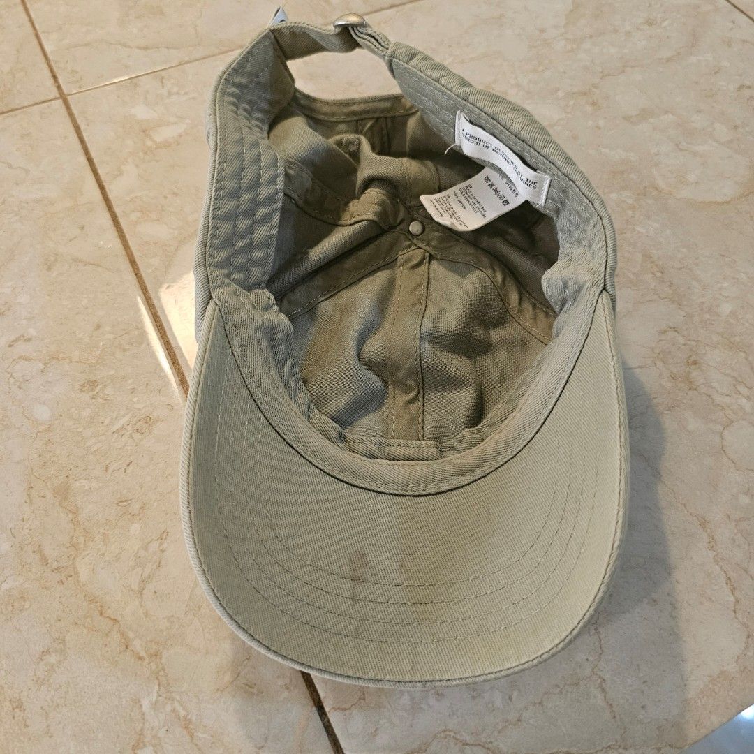 Beyond The Vines Sage Green Cap (Category: Hats & Beanies) located in Tagaytay City. Submitted by jesssipreloved (Listing ID 1469949330, Image 3). Description: Beyond The Vines cap in a sage green shade. Blue embroidered text on the front panel. Adjustable strap at the back with a silver metal slider. Inside tag reads 100% cotton, cold gentle cycle wash instructions. Shows some signs of wear. Just needs a bit of cleaning as seen on inner brim (3r