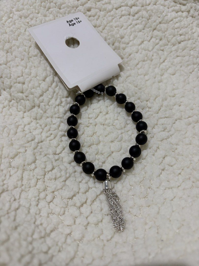 Black Beaded Bracelet with Silver Tassel Charm (Category: Bracelets) located in Paranaque City. Submitted by greatfinds108 (Listing ID 1469971029, Image 1). Description: - Brand new, unworn condition on original store packaging - Stylish black matte beads with silver metallic spacers - Trendy hanging chain tassel charm right at the center - Comfortable stretch cord fits most wrists easily - Recommended for ages 15 and up For pick up only.