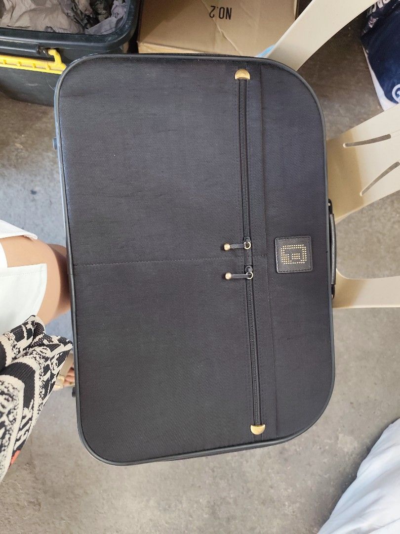 Black business travel briefcase with shoulder strap (Category: Briefcases) located in Bulacan. Submitted by gelvy1316 (Listing ID 1469951874, Image 3). Description: - Color: Professional black with chic gold-toned hardware - Carry Options: Sturdy top handle and a detachable shoulder strap with secure metal clasps - Exterior: Vertical zipper pocket on the front and a stylish logo patch - Interior: Wide-opening main compartment featuring packing st
