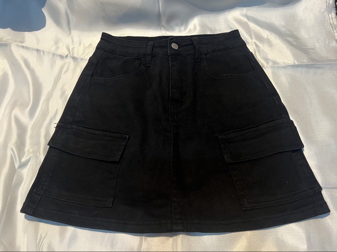 Black denim cargo mini skirt with front pockets (Category: Skirts) located in Manila. Submitted by ghengdhoze (Listing ID 1470069794, Image 1). Description: - Style: Utility cargo mini skirt - Color: Classic black - Details: Two large front cargo pockets, two back patch pockets, belt loops - Closure: Front button and zip fly - Fit: Versatile and easy to style with crop tops, tees, or hoodies - Condition: Brand new / Excellent quality w - 24 in L 