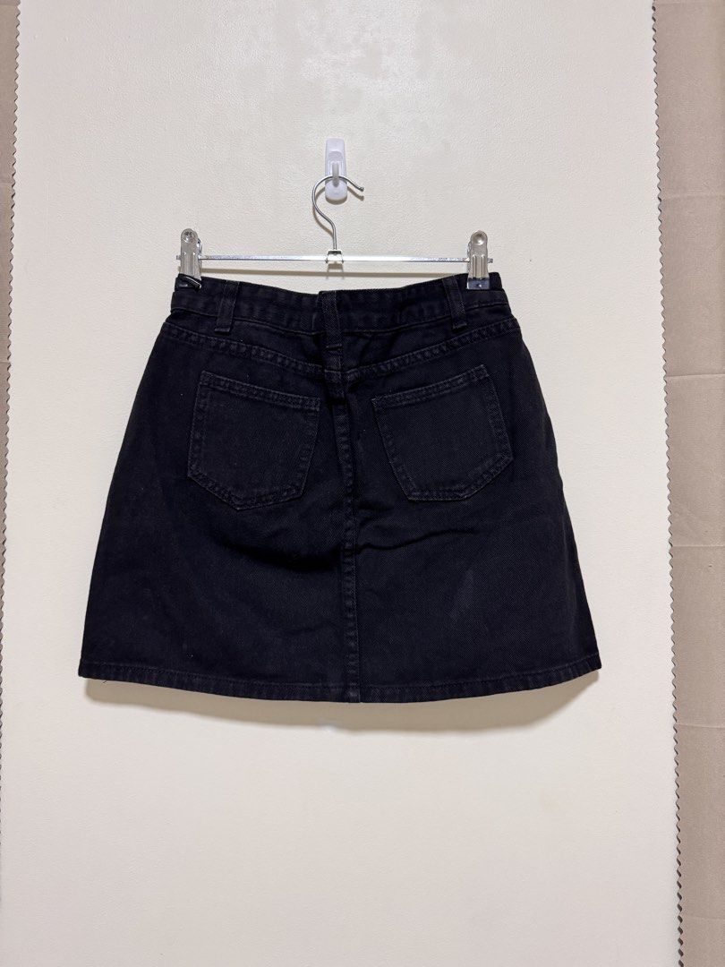 Black Denim Skirt (Category: Skirts) located in Manila. Submitted by seayouncey (Listing ID 1470054454, Image 2). Description: Size: waist line 27 inchs, length 14 inchs - Color: Classic Black - Style: Denim mini skirt with straight hem - Features: Button fly, belt loops, front pockets, and back patch pockets - Versatility: Easy to pair with tees, crop tops, and more - Condition: Brand new / Excellent quality.