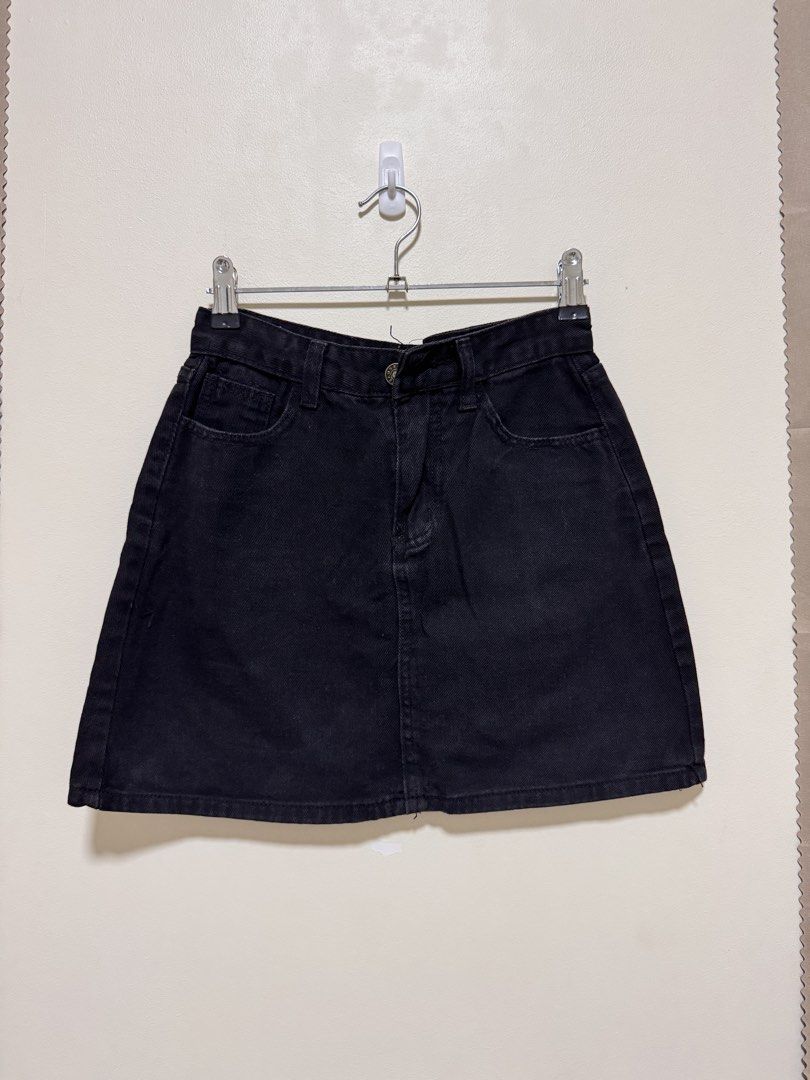 Black Denim Skirt (Category: Skirts) located in Manila. Submitted by seayouncey (Listing ID 1470054454, Image 1). Description: Size: waist line 27 inchs, length 14 inchs - Color: Classic Black - Style: Denim mini skirt with straight hem - Features: Button fly, belt loops, front pockets, and back patch pockets - Versatility: Easy to pair with tees, crop tops, and more - Condition: Brand new / Excellent quality.