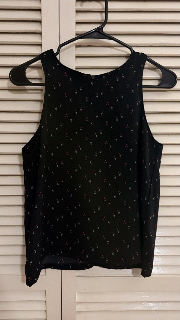 Black Ditsy Floral Print Cold Shoulder Blouse (Category: Sleeveless) located in Quezon City. Submitted by oliviablanche (Listing ID 1470115357, Image 1). Description: - Size: Free size (best fit S) - Black with Pink, Green, and Orange Floral Accents - Neckline: Round neckline with wide shoulder straps - Details: Ditsy floral print, cold shoulder cutouts, relaxed silhouette, and concealed back zipper closure - Styling: A feminine, versatile piece 