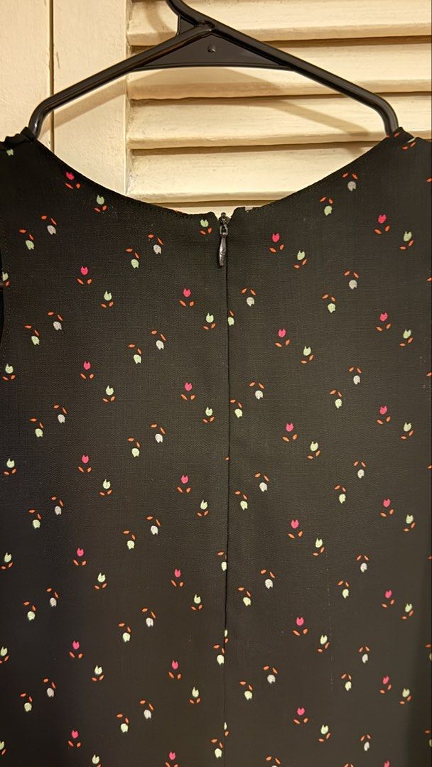 Black Ditsy Floral Print Cold Shoulder Blouse (Category: Sleeveless) located in Quezon City. Submitted by oliviablanche (Listing ID 1470115357, Image 3). Description: - Size: Free size (best fit S) - Black with Pink, Green, and Orange Floral Accents - Neckline: Round neckline with wide shoulder straps - Details: Ditsy floral print, cold shoulder cutouts, relaxed silhouette, and concealed back zipper closure - Styling: A feminine, versatile piece 