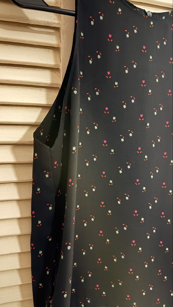 Black Ditsy Floral Print Cold Shoulder Blouse (Category: Sleeveless) located in Quezon City. Submitted by oliviablanche (Listing ID 1470115357, Image 2). Description: - Size: Free size (best fit S) - Black with Pink, Green, and Orange Floral Accents - Neckline: Round neckline with wide shoulder straps - Details: Ditsy floral print, cold shoulder cutouts, relaxed silhouette, and concealed back zipper closure - Styling: A feminine, versatile piece 