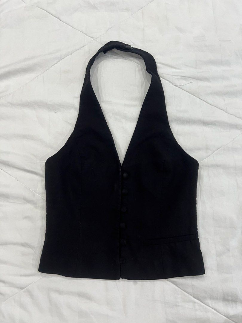 Black Halter Neck Button-Up Vest Waistcoat (Category: Sleeveless) located in Manila. Submitted by charmssin75605 (Listing ID 1470000097, Image 1). Description: - Color: Classic Black - Style: Sleeveless halter neck vest with adjustable back neck strap - Fit: Tailored fit with a sharp pointed hemline - Details: Deep V-neckline, front fabric-covered buttons, and a chic lower right welt pocket - Versatility: Perfect for layering over basic tees or w