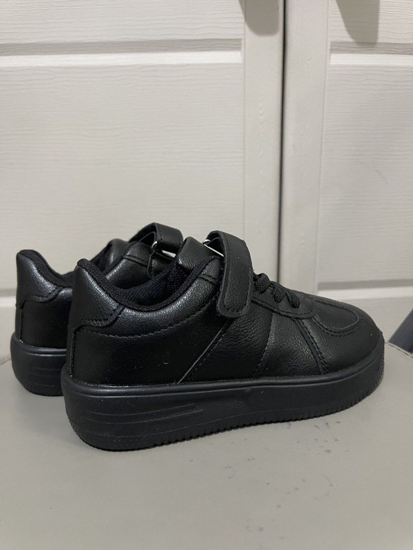 Black Kids Sneakers Velcro Strap Size 26 (Category: Babies & Kids Fashion) located in Quezon City. Submitted by preloveditemcollection (Listing ID 1469977067, Image 2). Description: - Size: 26 - Color: All-black - Closure: Elastic laces with top velcro strap for easy wear - Material: Smooth synthetic upper with thick, patterned rubber soles - Condition: Clean, soles look completely unworn - Origin: Made in China.