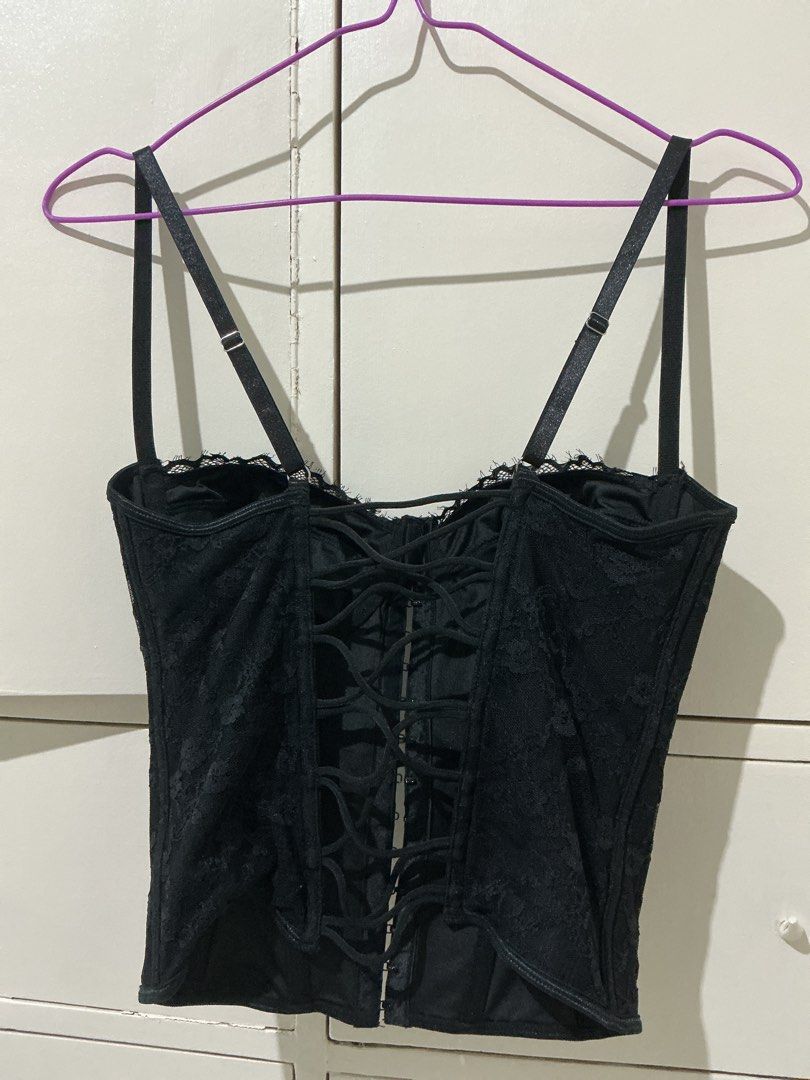 Black lace corset top with adjustable straps (Category: Sleeveless) located in Rizal. Submitted by kyliemaine (Listing ID 1470038087, Image 3). Description: - Style: Goth / Vintage lingerie vibe - Design: Black lace corset top with molded cups - Closure: Front hook-and-eye with lace-up crisscross back for adjustable fit - Straps: Adjustable double shoulder straps - Structure: Fully boned for support - Styling: Wear solo or layer over a basic tee.