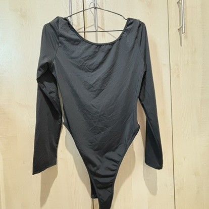 Black Long Sleeve Ruched Bodysuit (Category: Longsleeves) located in Quezon City. Submitted by slvrbullet (Listing ID 1470139961, Image 2). Description: - Color: Black - Style: Long sleeve bodysuit with fitted cut - Neckline & Back: Scoop neck and scoop back - Details: Trendy ruched front and high-cut leg opening - Fabric: Smooth and stretchy for a comfortable fit - Versatility: Great for layering or wearing on its own.