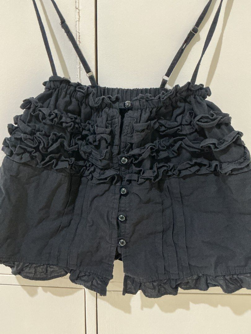 Black Ruffled Cami Top with Button Front (Category: Sleeveless) located in Rizal. Submitted by kyliemaine (Listing ID 1470028821, Image 2). Description: - Color: Black - Design: Ruffles across chest and hem with button-down front - Straps: Adjustable double spaghetti straps - Fit: Cropped, pairs well with high-waisted bottoms - Material: Lightweight and soft - Condition: Great shape, worn only a couple of times.
