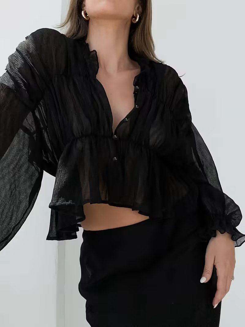 Black Sheer Ruffle Long Sleeve Button Up Blouse (Category: Longsleeves) located in Manila. Submitted by dianafayesimbre (Listing ID 1470088142, Image 2). Description: - Color: Black - Material: Lightweight sheer fabric - Design: Ruched front and back with button-down closure - Sleeves: Long balloon sleeves with ruffled cuffs - Neckline: High ruffled collar - Styling: Great for layering or pairing with high-waisted skirts - Brand new - Fits small 