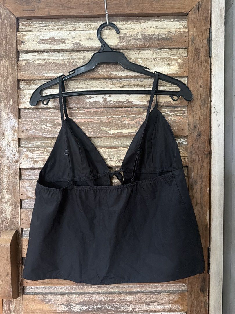 Black tie front camisole spaghetti strap top (Category: Sleeveless) located in Manila. Submitted by cb_____ (Listing ID 1469968556, Image 2). Description: - Color: Solid black - Style: Camisole top with thin spaghetti straps - Closure: Cute double fabric ties at the front - Fit: Elastic band at the top back edge for comfort and a secure fit - Material: Simple, lightweight, and breathable fabric - Versatility: Great for casual daytime wear, layeri